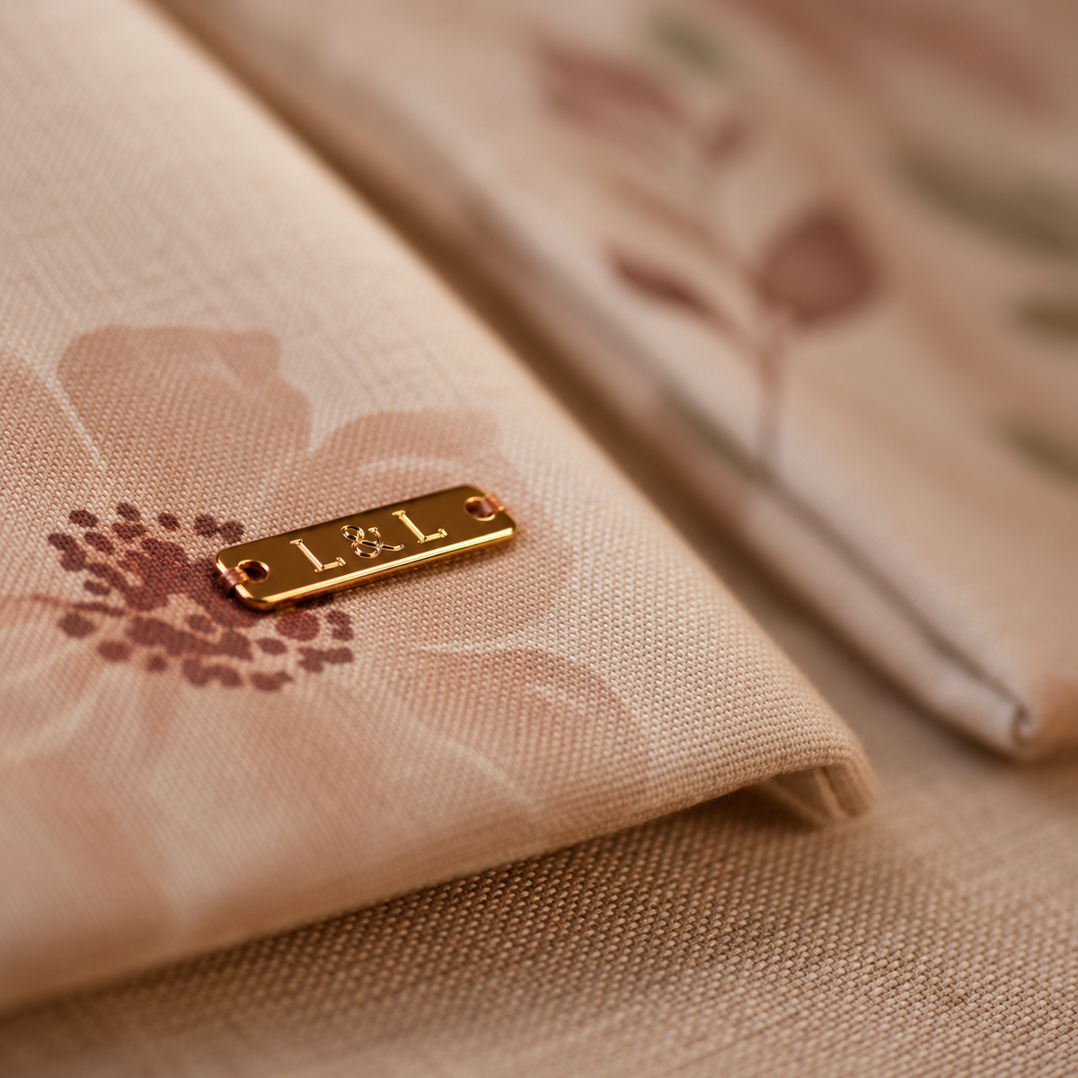 Close-up of floral Linen & Loaf bread bag fabric, gold label and hardware